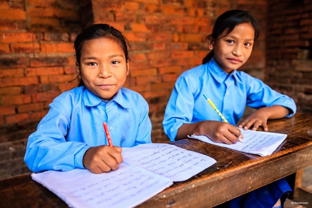 A smiling schoolboy with his open notebook