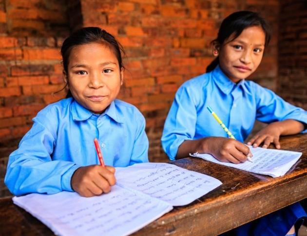 A smiling schoolboy with his open notebook